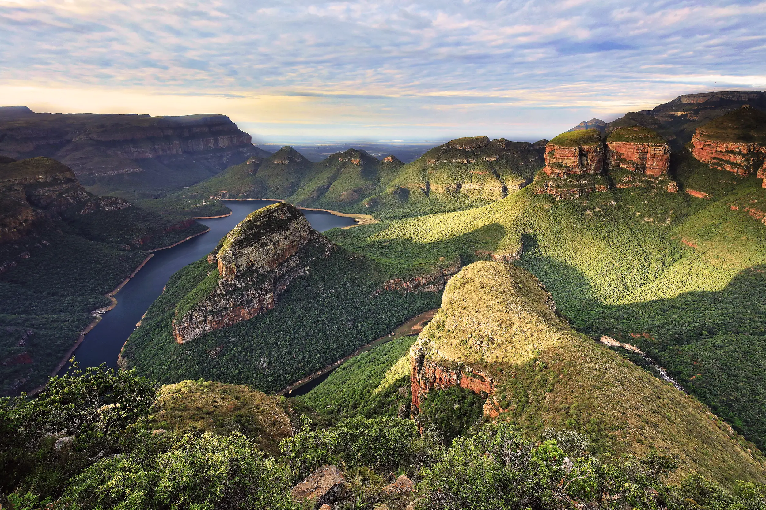 Voyage en Afrique du Sud : vue aérienne du canyon de la Blyde River entouré de montagnes verdoyantes dans la région du Mpumalanga.